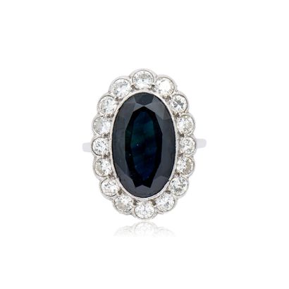 950° platinum RING centered on an oval sapphire...
