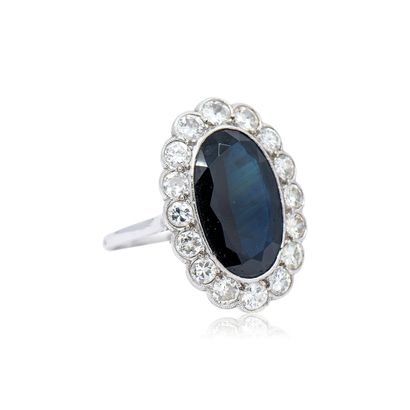 950° platinum RING centered on an oval sapphire...