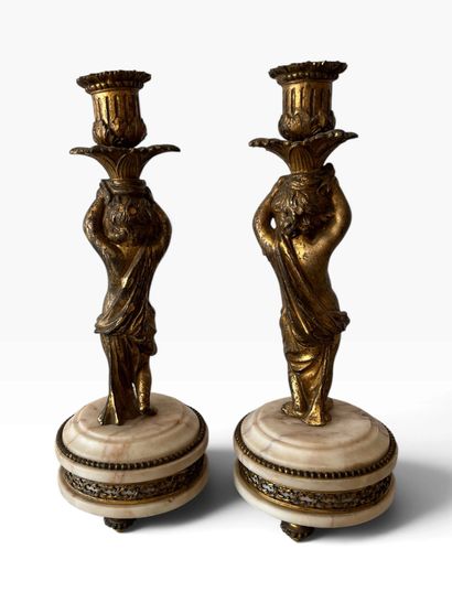 PAIR OF CANDLESTICKS decorated with cherubs,...