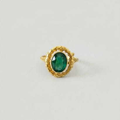 A yellow gold (.750) ring featuring an oval...