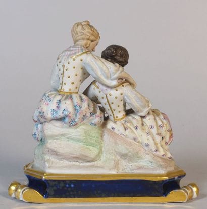 Polychrome porcelain group showing two young...