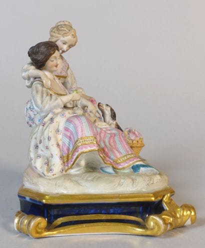Polychrome porcelain group showing two young...