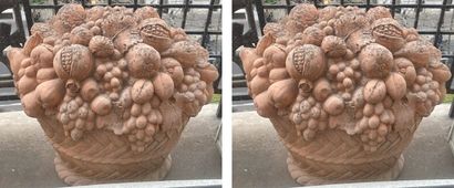 Two terracotta garden ornaments featuring...
