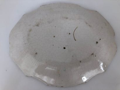 Three oval earthenware dishes with a contoured...