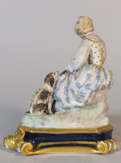 Polychrome porcelain group showing two young...