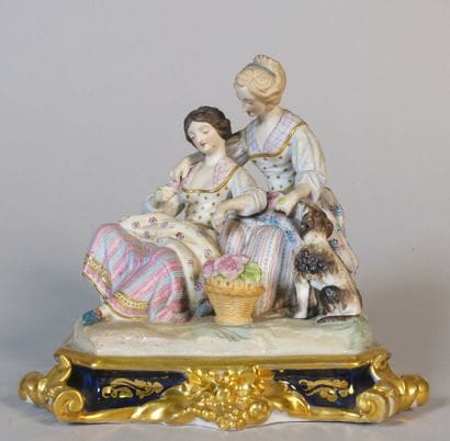 Polychrome porcelain group showing two young...