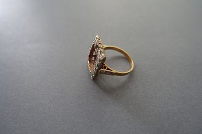 Gold ring setting paved with white and green...