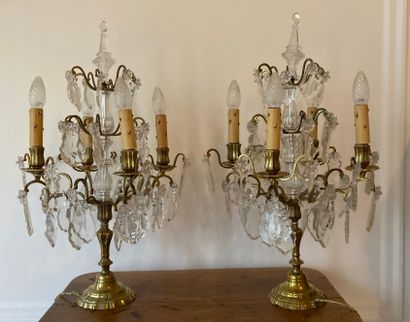 Pair of brass girandoles and four-light pendants.

Louis...