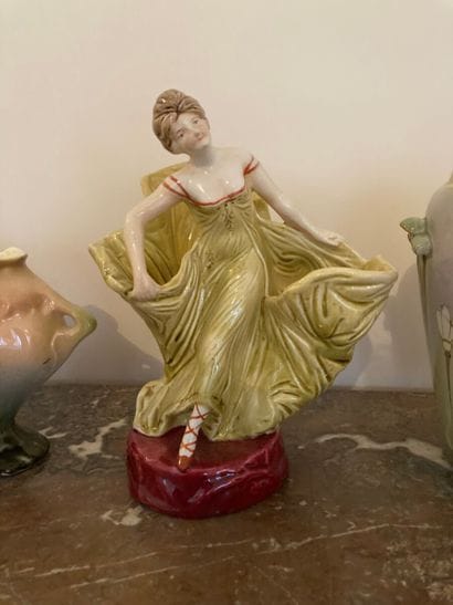 Two vases and a polychrome ceramic subject.

Art...