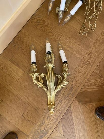 Pair of three-light gilt bronze sconces with...