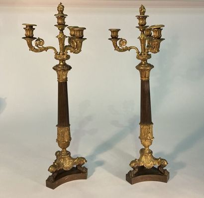 A pair of four-light patinated and gilt bronze...