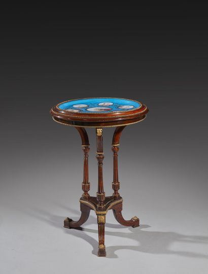 Circular table in mahogany, the top of porcelain...