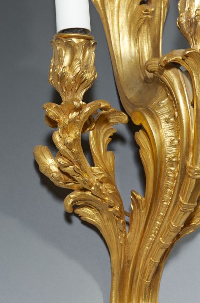 Pair of three-light gilt bronze sconces with...