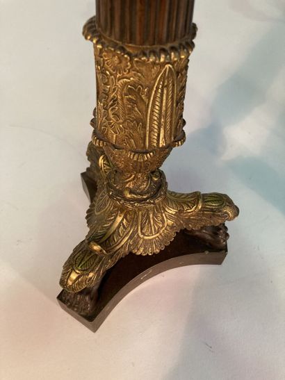 A pair of four-light patinated and gilt bronze...