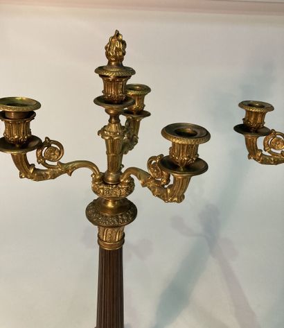 A pair of four-light patinated and gilt bronze...