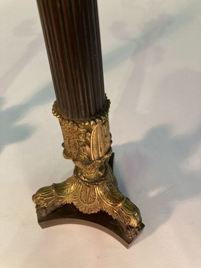 A pair of four-light patinated and gilt bronze...