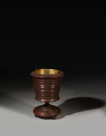 Molded mahogany bucket resting on a pedestal...