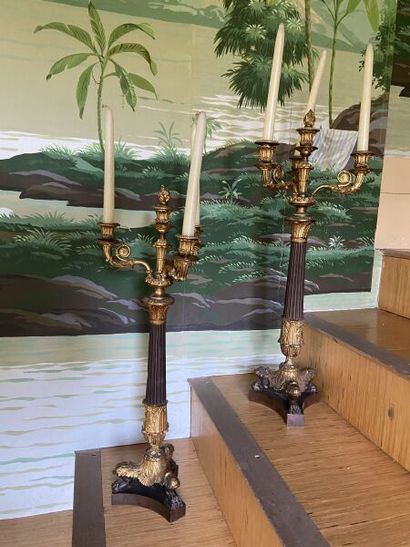 A pair of four-light patinated and gilt bronze...