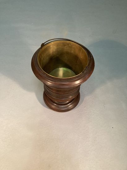 Molded mahogany bucket resting on a pedestal...