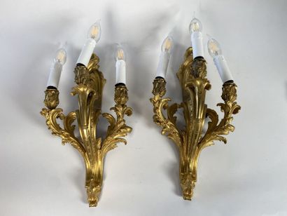 Pair of three-light gilt bronze sconces with...