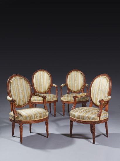 Suite of four molded and carved beech armchairs...