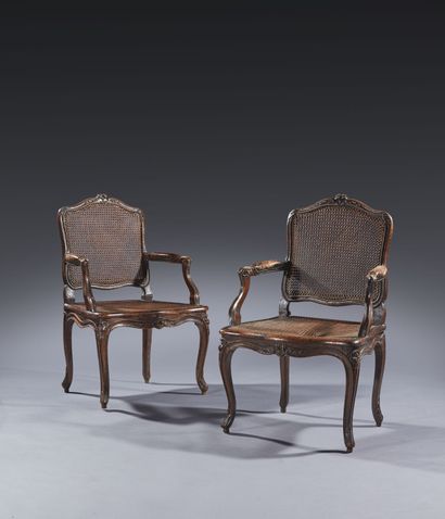 Pair of caned armchairs in molded and carved...