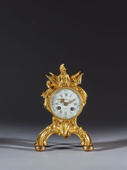 Gilt bronze clock decorated with trophies...