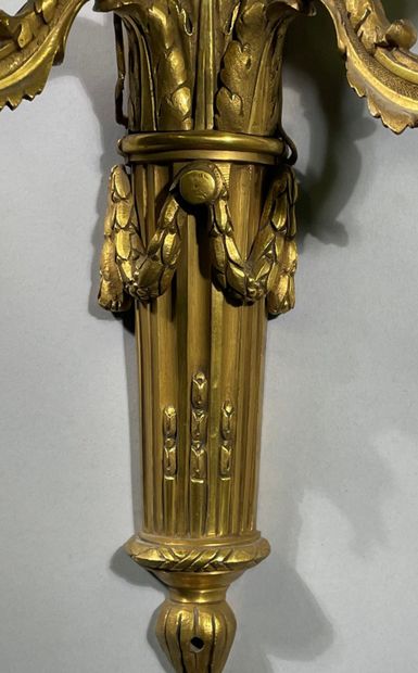 Pair of two-light ormolu sconces decorated...