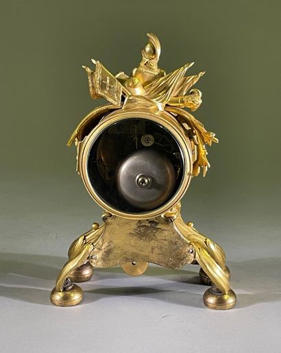 Gilt bronze clock decorated with trophies...