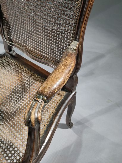 Pair of caned armchairs in molded and carved...