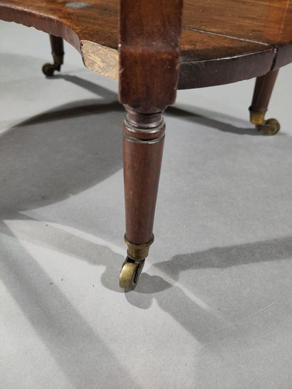 Oval molded mahogany table opening to three...
