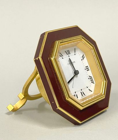 CARTIER
Hexagonal travel alarm clock in burgundy-enameled...