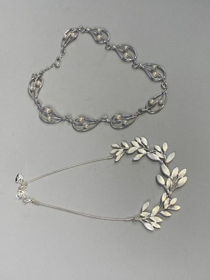 Set of two necklaces, one with leaves, the...