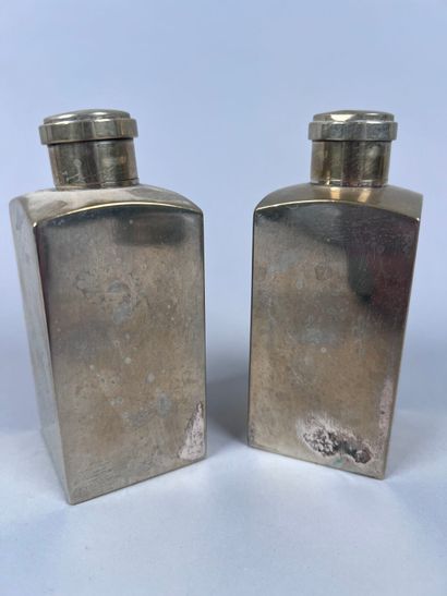 HERMÈS Paris
Two covered perfume bottles...