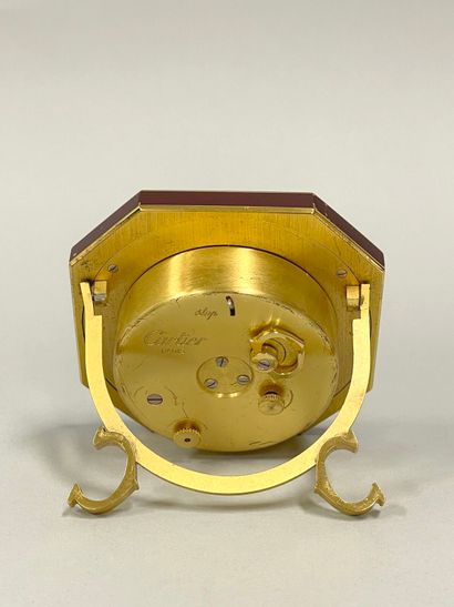 CARTIER
Hexagonal travel alarm clock in burgundy-enameled...