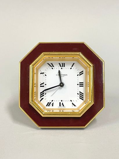 CARTIER
Hexagonal travel alarm clock in burgundy-enameled...