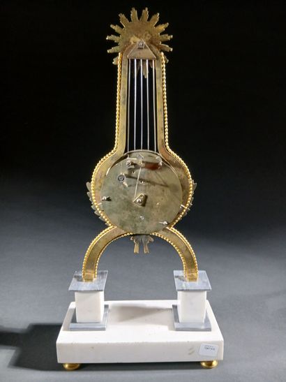 Skeleton lyre clock in gilded bronze and...