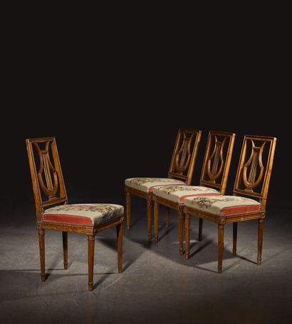 Four molded beech chairs with lyre-shaped...