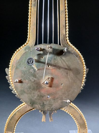 Skeleton lyre clock in gilded bronze and...