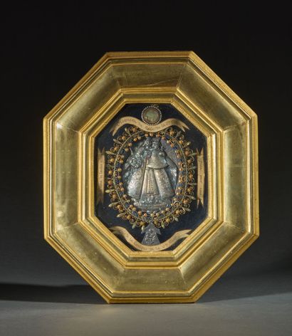 Gilded wood-framed octagonal reliquary containing...