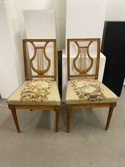 Four molded beech chairs with lyre-shaped...