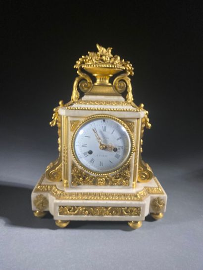 A white marble and gilded chiseled bronze...