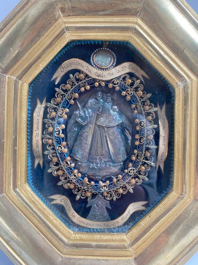 Gilded wood-framed octagonal reliquary containing...