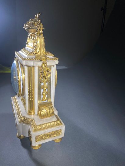A white marble and gilded chiseled bronze...