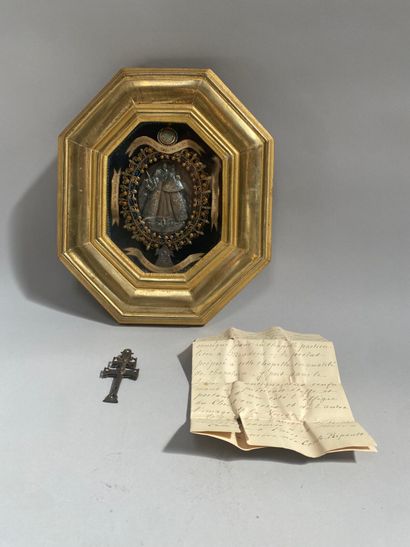 Gilded wood-framed octagonal reliquary containing...