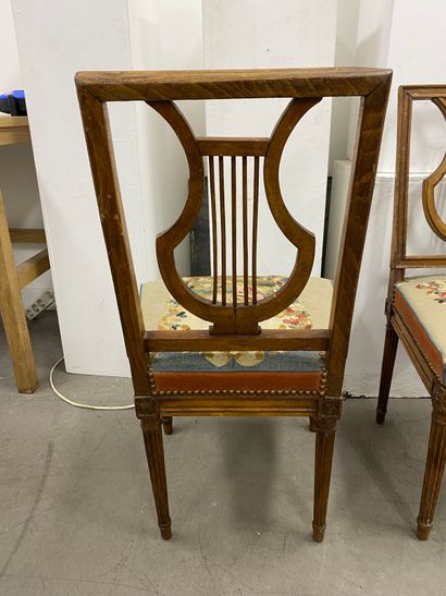 Four molded beech chairs with lyre-shaped...
