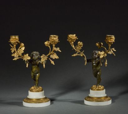 Pair of candelabras in chased and gilded...