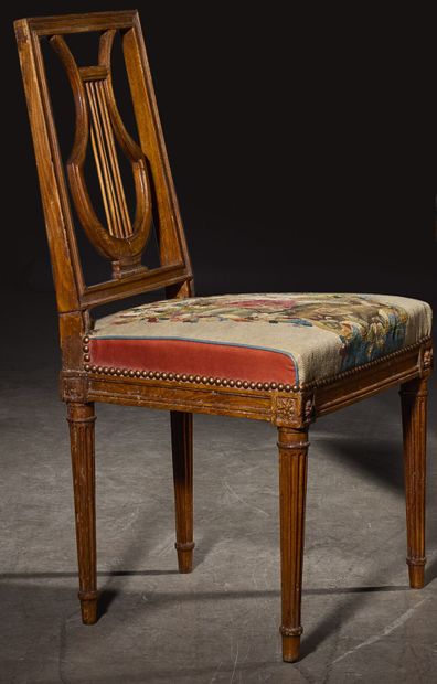 Four molded beech chairs with lyre-shaped...