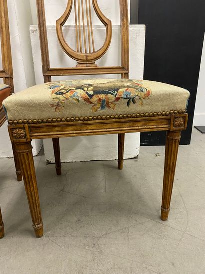 Four molded beech chairs with lyre-shaped...