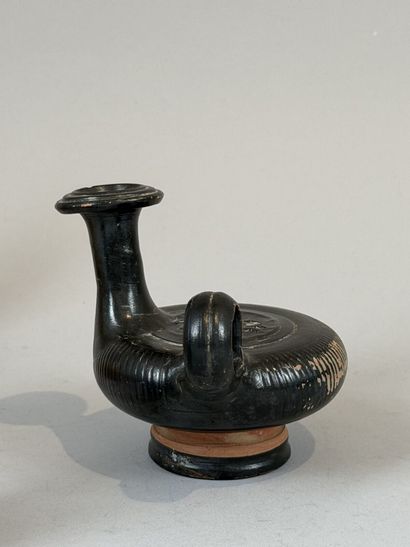 Guttus with a ribbed body, decorated with...